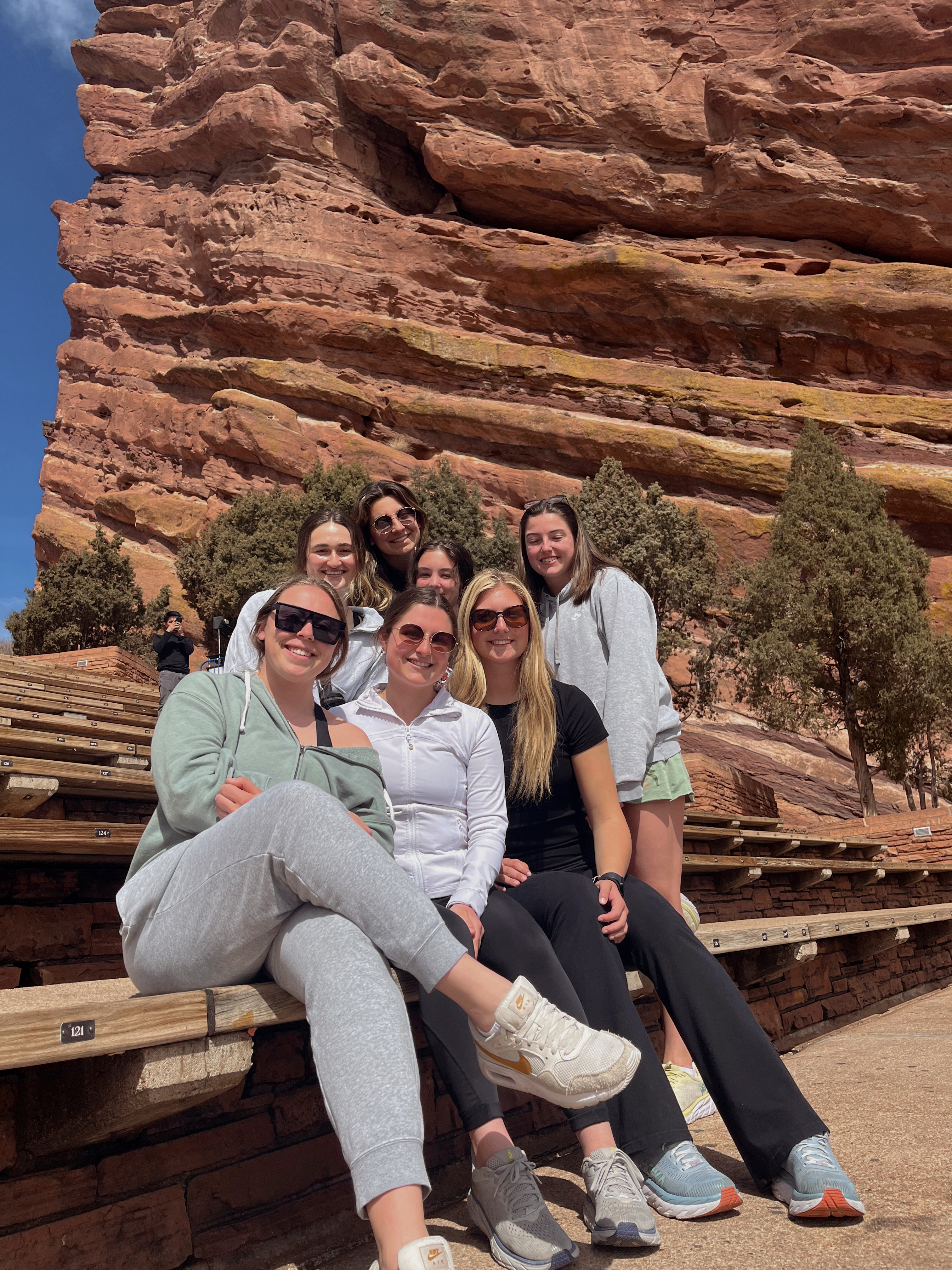 Group photo sitting at Red Rocks Ampitheater in
          Colorado