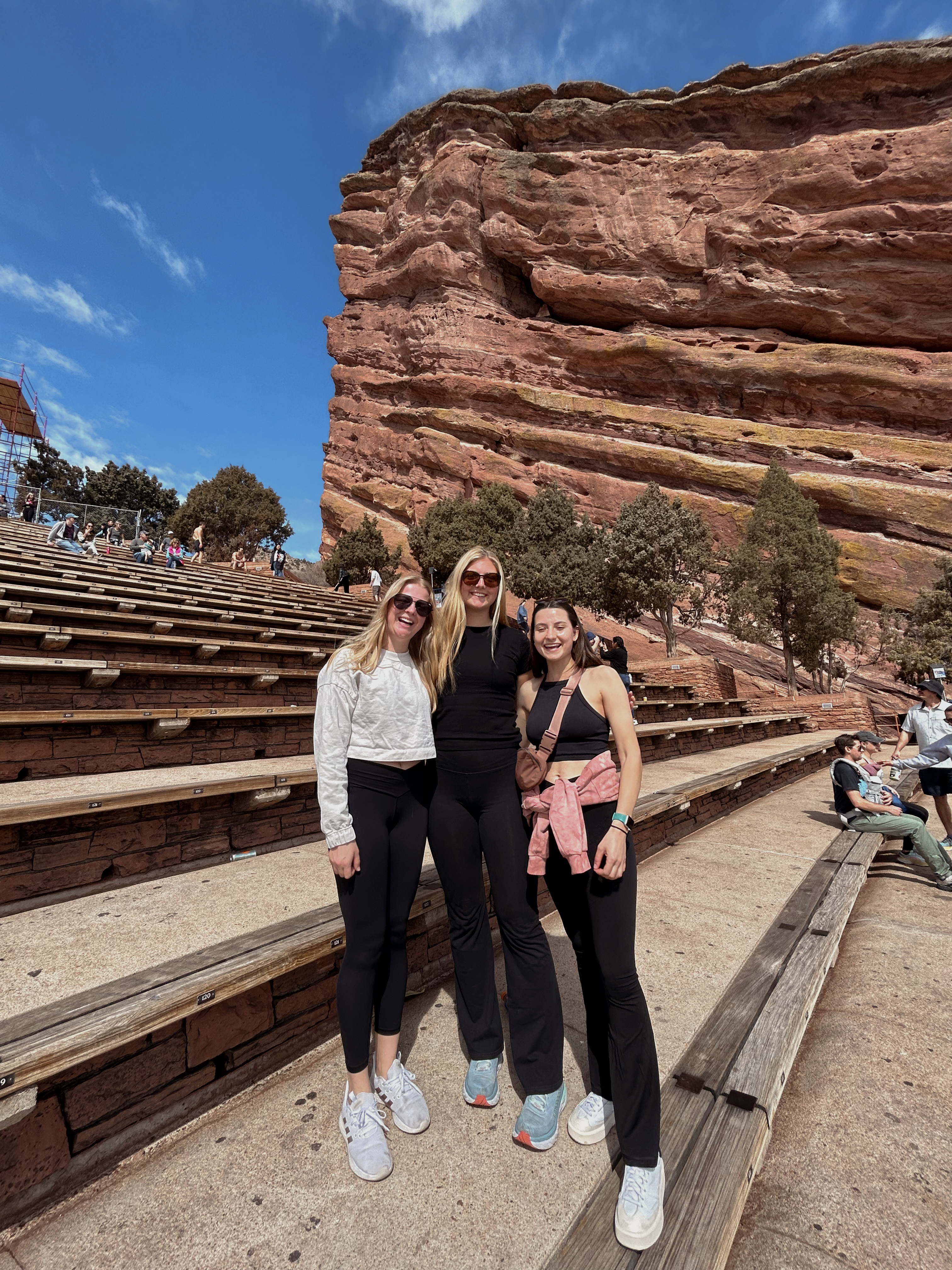 Three girls standing
          at Red Rocks Ampitheatre.