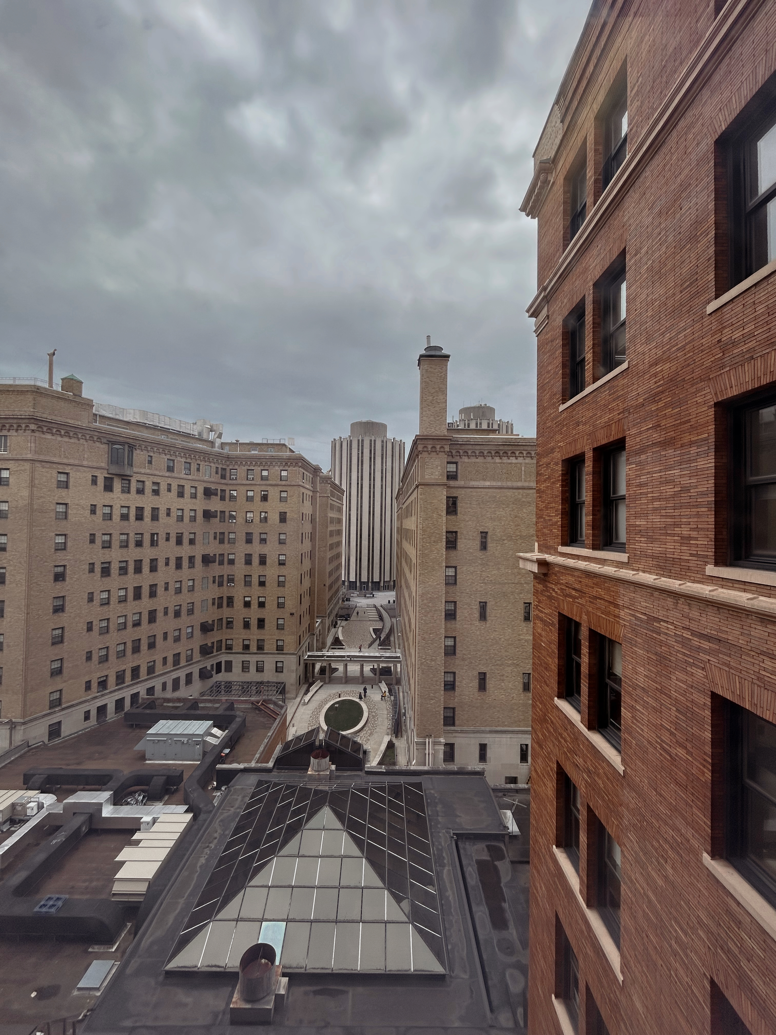 View from eighth floor of William Pitt Union. Tan brick dorm buildings in mid-gorund; 
                cylindrical Towers dorm buildings in background.